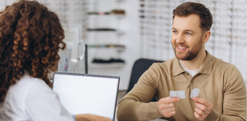Patient discussing contact lens options with an optician